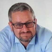 Iain Macdonald, portrait photo, smiling with glasses